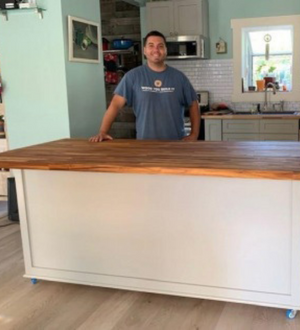 Justin, owner, standing behind custom kitchen island